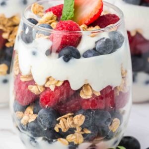 Gourmet Yoghurt Parfait: Layered creamy yogurt, fresh fruit, and crunchy granola. A refreshing, healthy dessert or breakfast option.