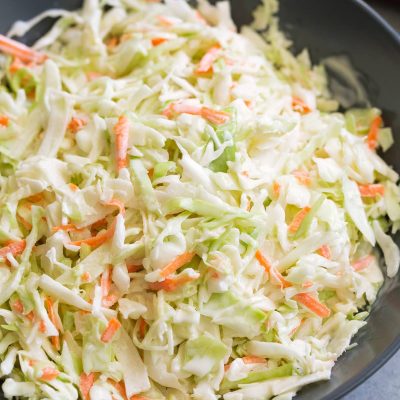 Fresh Creamy Coleslaw: Crisp cabbage and carrot slaw tossed in a light, tangy mayonnaise dressing. Perfect accompaniment.